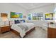 Relaxing primary bedroom with a comfortable bed, stylish decor, and serene views from the window at 13511 Esposito St, Venice, FL 34293