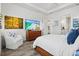 Bright and spacious bedroom with a large TV, dresser, chair, and easy access to the ensuite bath at 13511 Esposito St, Venice, FL 34293