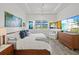 Tranquil primary bedroom with a comfortable bed, scenic views, and modern furnishings at 13511 Esposito St, Venice, FL 34293