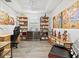 Stylish office with built-in shelves, a wine refrigerator, and unique decor for a functional workspace at 13511 Esposito St, Venice, FL 34293