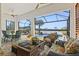 Inviting covered patio with ample seating and a peaceful view of the pool and waterfront at 13511 Esposito St, Venice, FL 34293