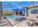 Covered pool area with outdoor seating and water feature at 13511 Esposito St, Venice, FL 34293