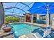 Inviting pool area with seating and a lush, landscaped view at 13511 Esposito St, Venice, FL 34293