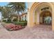 Inviting entrance to the Resort Center with colorful flowers, landscaping, and brick-paved walkway at 13511 Esposito St, Venice, FL 34293