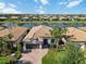 Beautiful aerial view of a home with a tile roof near a scenic lake in a tranquil neighborhood at 13872 Rinuccio St, Venice, FL 34293