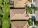 An aerial view showcases several homes with lovely landscaping and orange tile roofs in this delightful neighborhood at 13872 Rinuccio St, Venice, FL 34293