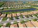 Stunning aerial view showcasing a community with well-kept homes, serene lakes, and lush landscaping at 13872 Rinuccio St, Venice, FL 34293