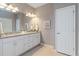 Bathroom featuring double sink vanity with granite countertop and bright lighting at 13872 Rinuccio St, Venice, FL 34293