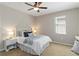 Bedroom with ceiling fan, bright window, and minimalist decor at 13872 Rinuccio St, Venice, FL 34293