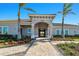 Beautiful clubhouse entrance with manicured landscaping, showcasing a welcoming community space at 13872 Rinuccio St, Venice, FL 34293