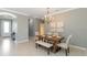 Cozy dining room featuring a modern chandelier and a view towards the entryway at 13872 Rinuccio St, Venice, FL 34293