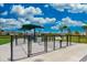 Community dog park featuring separate areas for big and small dogs with green space and shade at 13872 Rinuccio St, Venice, FL 34293