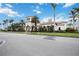 Exterior of clubhouse with Mediterranean architectural details, landscaping, and well-maintained grounds under a blue sky at 13872 Rinuccio St, Venice, FL 34293
