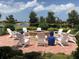 Cozy outdoor fire pit surrounded by comfortable chairs, perfect for gatherings and relaxation near the water at 13872 Rinuccio St, Venice, FL 34293
