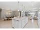 Bright kitchen and dining area with a large center island, stainless appliances, and lots of counter space at 13872 Rinuccio St, Venice, FL 34293