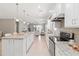 This spacious kitchen features stainless steel appliances and a large island for meal preparation and gathering at 13872 Rinuccio St, Venice, FL 34293