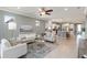 Inviting living room with tiled floors, neutral decor, and an open layout with an island kitchen at 13872 Rinuccio St, Venice, FL 34293