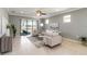 Inviting living room with tiled floors, neutral decor, and a view to a lake at 13872 Rinuccio St, Venice, FL 34293