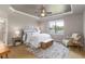 Serene main bedroom with tray ceiling, king-sized bed, and large window overlooking the backyard at 13872 Rinuccio St, Venice, FL 34293