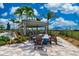Outdoor pavilion with seating and fire pit, designed for social gatherings and relaxation by the pool at 13872 Rinuccio St, Venice, FL 34293