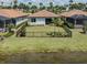 Landscaped backyard enclosed by a black fence bordering a tranquil lake at 149 Vinadio Blvd, Nokomis, FL 34275