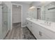 Bright bathroom with double vanity, a walk-in shower, and a walk-in closet at 149 Vinadio Blvd, Nokomis, FL 34275