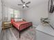 Bedroom featuring gray walls, wood-look floors, and a modern bed at 149 Vinadio Blvd, Nokomis, FL 34275