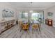 Bright dining area with a modern chandelier and sliding door access to the lanai and grill at 149 Vinadio Blvd, Nokomis, FL 34275