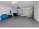 Spacious garage with a sectional door and light gray epoxy flooring at 149 Vinadio Blvd, Nokomis, FL 34275