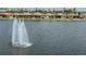Picturesque lakeside property with a water fountain as viewed from across the lake at 149 Vinadio Blvd, Nokomis, FL 34275