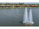 Scenic lake view featuring a water fountain with surrounding homes along the waterside at 149 Vinadio Blvd, Nokomis, FL 34275