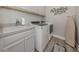 Laundry room with a sink, washer, dryer, and lots of storage space at 149 Vinadio Blvd, Nokomis, FL 34275
