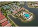 Aerial view of the community pool, tennis courts, and clubhouse in Toscana Isles at 149 Vinadio Blvd, Nokomis, FL 34275