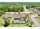 Aerial view of home with a screened in pool, fenced yard, mature trees, and well-maintained lawn at 1510 Haffenberg Ave, North Port, FL 34288