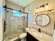 Bathroom with glass shower, pebble flooring, and modern vanity at 1510 Haffenberg Ave, North Port, FL 34288