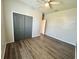 Bedroom featuring wood floors, a ceiling fan, a closet with bi-fold doors, and neutral walls at 1510 Haffenberg Ave, North Port, FL 34288