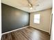 Bedroom with wood flooring, ceiling fan, one window, and two-tone painted walls at 1510 Haffenberg Ave, North Port, FL 34288
