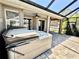 Covered patio featuring a hot tub and access to the screened pool area at 1510 Haffenberg Ave, North Port, FL 34288