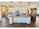 Spacious kitchen featuring a center island, white cabinets, stainless steel appliances, and custom backsplash at 1510 Haffenberg Ave, North Port, FL 34288