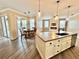 Open kitchen flows into the dining area and features an island and modern pendant lighting at 1510 Haffenberg Ave, North Port, FL 34288