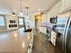 Open kitchen with stainless steel appliances, light cabinetry, and an island with stone countertops at 1510 Haffenberg Ave, North Port, FL 34288