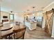 Open kitchen with a center island, stainless steel appliances, and a wooden sliding barn door at 1510 Haffenberg Ave, North Port, FL 34288