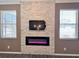 Living room featuring a stone fireplace wall with modern electric fireplace and flat screen TV at 1510 Haffenberg Ave, North Port, FL 34288