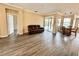 Spacious living room with wood floors, neutral paint, and sliding glass doors to the backyard at 1510 Haffenberg Ave, North Port, FL 34288