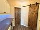 Pantry with a wooden barn door, built-in shelving, and countertop space at 1510 Haffenberg Ave, North Port, FL 34288
