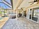 Large covered patio features a hot tub and multiple access points to both the home and backyard at 1510 Haffenberg Ave, North Port, FL 34288