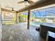 Screened in patio with ceiling fans featuring a pool, hot tub and plenty of room to entertain at 1510 Haffenberg Ave, North Port, FL 34288