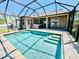 Screened pool and hot tub area extending from the home with a brick paver patio at 1510 Haffenberg Ave, North Port, FL 34288