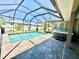 Screened pool and hot tub on brick paver patio, creating an ideal outdoor retreat at 1510 Haffenberg Ave, North Port, FL 34288