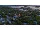 Aerial view of a residential area with lush greenery, showcasing the property's location near the coast at 1629 Siesta Dr, Sarasota, FL 34239